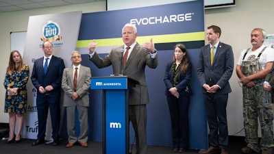 Minnesota Gov. Tim Walz speaks during a news conference after touring Phillips & Temro in Eden Prairie, Minn. Monday, July 26, 2021. Minnesota became the first Midwestern state to adopt a plan for encouraging the switchover to electric vehicles, as Gov. Walz predicted that someday people will wonder why there was such as fuss.