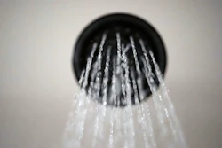 In this Aug. 12, 2020 file photo, water flows from a showerhead in Portland, Ore. President Joe Biden's administration is reversing a Trump-era rule approved after the former president complained he wasn’t getting wet enough because of limits on water flow from showerheads. Now, with a new president in office, the Energy Department is going back to a standard adopted in 2013, saying it provides plenty of water for a good soak and a thorough clean.