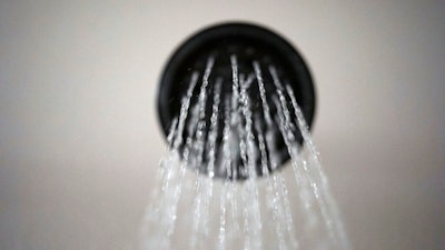 In this Aug. 12, 2020 file photo, water flows from a showerhead in Portland, Ore. President Joe Biden's administration is reversing a Trump-era rule approved after the former president complained he wasn’t getting wet enough because of limits on water flow from showerheads. Now, with a new president in office, the Energy Department is going back to a standard adopted in 2013, saying it provides plenty of water for a good soak and a thorough clean.