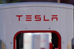 The company logo is shown at the top of a supercharger for Tesla automobiles near shops Feb. 25, 2021 in Boulder, Colo. Tesla's quarterly profit has surpassed $1 billion for the first time thanks to the electric car pioneer's ability to navigate through a pandemic-driven computer chip shortage that has caused major headaches for other automakers. The financial milestone announced Monday, July 26, 2021 extended a two-year run of prosperity that has erased questions about Tesla’s long-term viability raised during its early years of losses and production problems.
