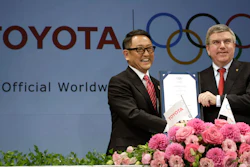 In this March 13, 2015 file photo, Toyota President and CEO Akio Toyoda, left, and IOC President Thomas Bach pose with a signed document during a press conference in Tokyo as Toyota signed on as a worldwide Olympic sponsor in a landmark deal.