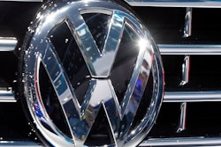 In this Sept. 22, 2015, file photo, the logo of Volkswagen at a car is photographed during the Car Show in Frankfurt, Germany. Luxury brands Audi and Porsche are fattening the bottom line at German automaker Volkswagen. The company's premium brands saw record sales in the first half of the year. That helped the Wolfsburg-based auto giant make more money than it did even before the pandemic. The company made 11.4 billion euros, or $13.5 billion, in the first half of the year.