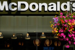 A customer walks in a McDonald's restaurant, in London, Tuesday, Aug. 24, 2021. McDonald’s says it has pulled milkshakes from the menu in all 1,250 of its British restaurants because of supply problems stemming from a shortage of truck drivers. The fast-food chain says it is also experiencing shortages of bottled drinks.