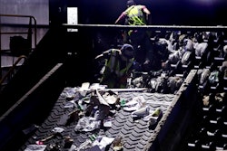 In this Thursday, Sept. 6, 2018, file photo, workers clean consumer plastic shopping bags from the clogged rollers of a machine which separates paper, plastic and metal recyclable material, in a processing building at EL Harvey & Sons, a waste and recycling company, in Westborough, Mass. States around the country are looking to adopt new recycling regimes that require producers of packaging to pay for its inevitable disposal.