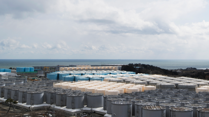 In this Feb. 27, 2021, file photo, tanks (in gray, beige and blue) store water that was treated but is still radioactive after it was used to cool down spent fuel at the Fukushima Daiichi nuclear power plant in Okuma town, Fukushima prefecture, northeastern Japan.