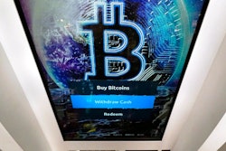 In this Feb. 9, 2021, file photo, the Bitcoin logo appears on the display screen of a cryptocurrency ATM at the Smoker's Choice store in Salem, N.H. China’s central bank on Friday, Sept. 24, 2021, declared all transactions involving Bitcoin and other virtual currencies illegal, stepping up a campaign to block use of unofficial digital money.