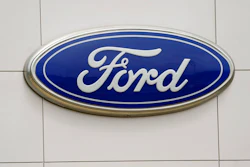 A Ford logo is seen on signage at Country Ford in Graham, N.C., Tuesday, July 27, 2021. Ford Motor Co. has hired a former executive from Apple and Tesla to be the company's head of advanced technology and new embedded systems, a critical post as the auto industry moves to adopt vehicles powered by electricity and guided by computers.