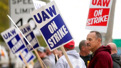 John Deere Dubuque Works union employee Steve Thor pickets outside UAW Local 94 in Dubuque, Iowa, on Oct. 14, 2021.