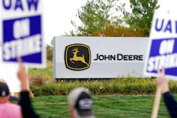 Members of the United Auto Workers strike outside of a John Deere plant on Oct. 20, 2021, in Ankeny, Iowa.