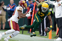 The Green Bay Packers' Davante Adams is pushed out of bounds by Washington's Kendall Fuller after making a catch, Lambeau Field, Green Bay, Wis., Oct. 24, 2021.