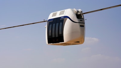 A small, four-seat pod made by uSky glides above a test track in Sharjah, United Arab Emirates, Oct. 28, 2021.