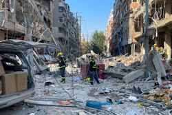 In this photo released by Xinhua News Agency, policemen and firefighters walk through damaged shophouses following a gas explosion in Shenyang in northeastern China's Liaoning Province, Thursday, Oct. 21, 2021. Several people were killed and over dozen injured in the gas explosion at a restaurant in northeastern Chinese city Shenyang Thursday morning, according to local authorities.