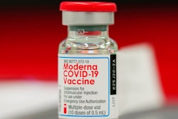 This Wednesday, Dec. 23, 2020 file photo shows a vial of the Moderna COVID-19 vaccine in the first round of staff vaccinations at a hospital in Denver. On Thursday, Oct. 14, 2021, U.S. health advisers said that some Americans who received Moderna’s COVID-19 vaccine should get a half-dose booster to bolster protection against the virus.
