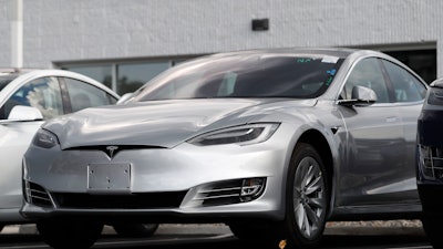 This July 8, 2018 photo shows Tesla 2018 Model 3 sedans sit on display outside a Tesla showroom in Littleton, Colo. Tesla wants to keep secret its response to the U.S. government’s request for information in an investigation of its Autopilot partially automated driving system.