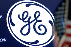 The General Electric logo appears above a trading post on the floor of the New York Stock Exchange, June 26, 2018. General Electric is splitting itself into three public companies that concentrate on aviation, healthcare and energy. The company said Tuesday, Nov. 9, 2021, that it plans a spinoff of its healthcare business in early 2023 and of its energy segment in early 2024.
