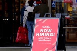 Hiring sign is displayed outside of a retail store in Vernon Hills, Ill., Saturday, Nov. 13, 2021. The number of Americans applying for unemployment benefits plummeted last week to the lowest level in more than half a century, another sign that the U.S. job market is rebounding rapidly from last year’s coronavirus recession.