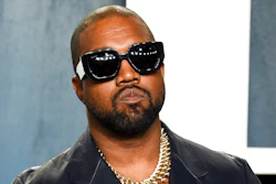 In this Feb. 9, 2020, file photo, Kanye West arrives at the Vanity Fair Oscar Party in Beverly Hills, Calif. Rapper and fashion mogul Ye’s high-end clothing company Yeezy has agreed to pay $950,000 to settle a lawsuit over slow shipping to customers.