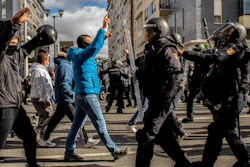 Protesters, left, march during a strike organized by metal workers in Cadiz, southern Spain, Tuesday, Nov. 23, 2021.