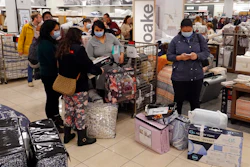 Customers wait in line to checkout during a Black Friday sale at Macy's on Nov. 26, 2021, in Indianapolis.
