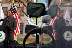 Environmental Protection Agency (EPA) Administrator Michael Regan is reflected in an electronic vehicle as it charges as he speaks during an event to announce the Agency's final rule for federal greenhouse gas (GHG) emissions standards for light duty vehicles, Monday, Dec. 20, 2021, outside the EPA Headquarters, in Washington.