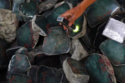 A merchant examines a jade stone displayed at the Gems Emporium in Naypyitaw, Myanmar on Nov. 13, 2018. Human rights activists are lobbying major jewelers to stop buying gems sourced in Myanmar as a way to exert pressure on Myanmar’s military leaders by limiting profits from the country’s lucrative mining industry.
