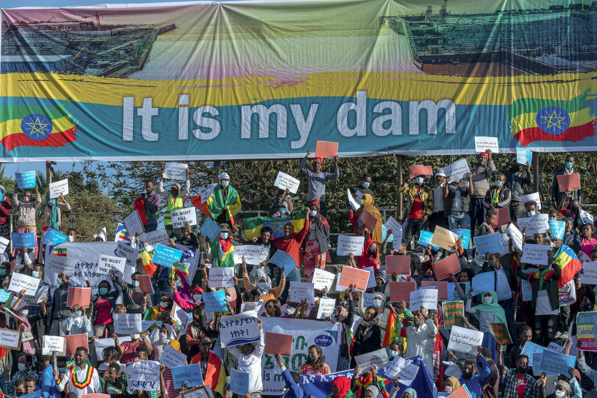Ethiopians protest against international pressure on the government over the conflict in Tigray, below a banner referring to the Grand Ethiopian Renaissance Dam, Addis Ababa, May 30, 2021.