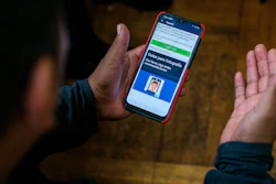 Ecuadorian immigrant Neptali Chiluisa shows the app that he uses for reporting his location to Immigration authorities, New York, Oct. 21, 2021.