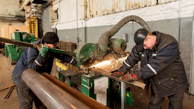 Two workers weld metal inside the Interpipe Steel plant in Dnipro, Ukraine, Thursday, March 10, 2022.