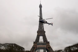A helicopter installs a new telecom transmission TDF antenna on the top of the Eiffel Tower in Paris, March 15, 2022.