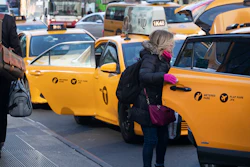 A passenger gets into a taxi, New York, Jan. 29, 2020.