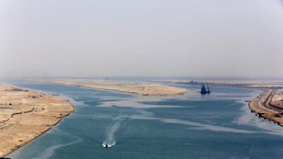 An army zodiac secures the entrance of a new section of the Suez Canal in Ismailia, Egypt, Aug. 6, 2015. Cash-strapped Egypt increased transit fees Tuesday, March 1, 2022, for ships passing through the Suez Canal, one of the world’s most crucial waterways, with hikes of up to 10%, officials said.