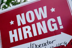 A 'now hiring' sign is posted in Garnet Valley, Pa., Monday, May 10, 2021. Applications for unemployment benefits inched down last week, Thursday, April 21, 2022, as the total number of Americans collecting aid fell to its lowest level in more than 50 years.