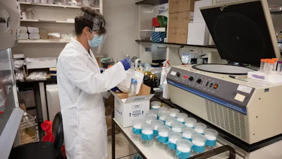 A lab technician prepares to process wastewater samples for SARS-CoV-2 detection at Colorado State University.