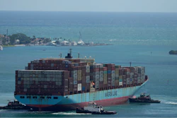 Three tugboats work together to rotate the Axel Maersk container ship as it arrives into port, on Oct. 21, 2021, in Miami.