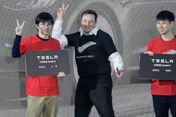 In this photo released by China's Xinhua News Agency, Tesla CEO Elon Musk, center, poses with Tesla owners at a delivery ceremony for the first Tesla Model 3 cars made at Tesla's Shanghai factory in Shanghai on Jan. 7, 2020. Musk’s ties to China through his role as electric car brand Tesla’s biggest shareholder could add complexity to his bid to buy Twitter.