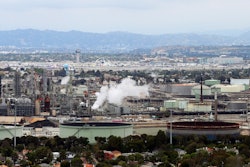 This aerial photo shows the Standard Oil Refinery in El Segundo, Calif., with Los Angeles International Airport in the background and the El Porto neighborhood of Manhattan Beach, Calif., in the foreground on May 25, 2017. A plan released by the California Air Resources Board on Tuesday, May 10, 2022, recommends a majority of the state's oil refineries install carbon capture technology by 2030. Such technology could be used to capture carbon emissions so they don't go out into the atmosphere.