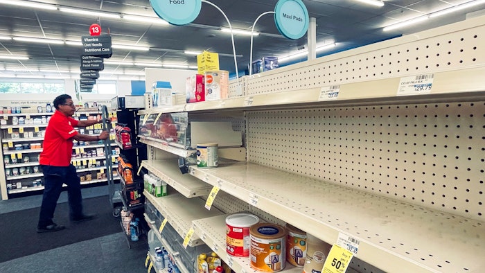 An employee walks near empty shelves where baby formula would normally be located at a CVS in New Orleans on Monday, May 16, 2022. President Joe Biden's administration has announced new steps to ease the national shortage of baby formula, including allowing more imports from overseas.