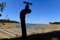 In this May 22, 2021, file photo, water drips from a faucet near boat docks sitting on dry land at the Browns Ravine Cove area of drought-stricken Folsom Lake in Folsom, Calif. California Gov. Gavin Newsom threatened Monday, May 23, 2022, to impose mandatory, statewide restrictions on water use if people don't start using less on their own as the drought drags on and the hotter summer months approach.