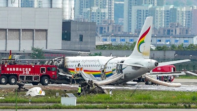 In this photo released by Xinhua News Agency, a passenger jet that veered off a runway during take-off and caught fire is seen in the aftermath in Chongqing Jiangbei International Airport in southwestern China's Chongqing Thursday, May 12, 2022. The Chinese passenger jet left the runway upon takeoff and caught fire in western China on Thursday morning, and several people were injured.