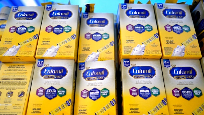 Infant formula is stacked on a table during a baby formula drive to help with the shortage May 14, 2022, in Houston. President Joe Biden has invoked the Defense Production Act to speed production of infant formula and has authorized flights to import supply from overseas.