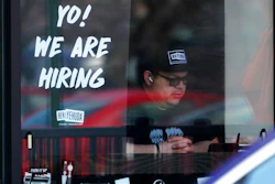 A hiring sign is displayed at a restaurant in Schaumburg, Ill., April 1, 2022. Employers posted a record 11.5 million job openings in March, more evidence of a tight labor market that has emboldened millions of American workers to leave their jobs and contributed to the biggest surge in inflation in four decades. A record 4.5 million Americans quit their jobs in February — a sign that they are confident they can find better pay or working conditions elsewhere.
