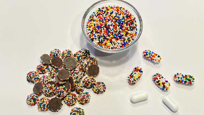 Chocolate drops covered with candy nonpareils (left), a bowl of colorful candy nonpareils (center), pharmaceutical caplets coated with nonpareils (right).