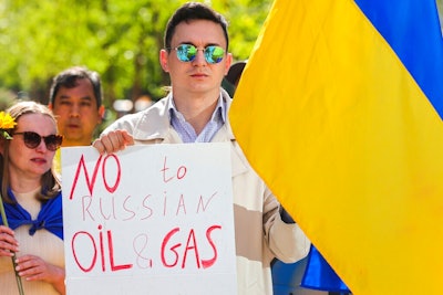 Ukrainian demonstrators demand an embargo on Russian oil during a protest in front of EU institutions prior to an extraordinary meeting of EU leaders to discuss Ukraine, energy and food security at the Europa building in Brussels, Monday, May 30, 2022.