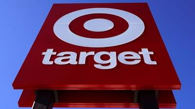 The bullseye logo on a sign outside a Target store is seen on Feb. 28, 2022. Target's first-quarter profit took a big hit from higher costs, despite strong sales growth. Target's results Wednesday, May 18, reflect the pressure on retailers' profits coming from surging inflation and persistent clogs in the supply chain.