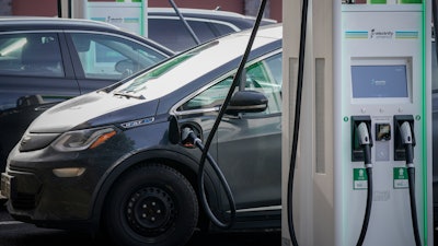An electric Chevrolet Bolt charges at an Electrify America site in Lakewood, Colo., on Dec. 21, 2020. In Connecticut, officials have begun rolling out a wide-ranging new law aimed at reducing vehicle emissions, including adding 10 more electric vehicles that will now be eligible for the state's rebate program.