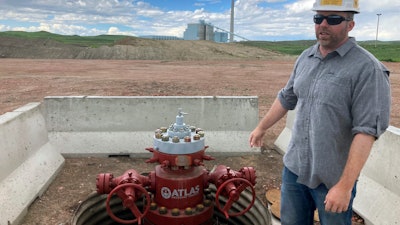 Fred McLaughlin, director of the Center for Economic Geology Research at the University of Wyoming, stands near one of two wells drilled near the Dry Fork Station coal-fired power plant outside Gillette, Wyo., on June 14, 2022. McLaughlin and other researchers are studying whether formations as deep as 10,000 feet can be used to store the power plant’s carbon dioxide emissions.