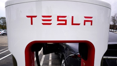 Tesla Supercharger is seen at Willow Festival shopping plaza parking lot in Northbrook, Ill., on May 5, 2022. Tesla shareholders on Thursday, Aug. 4, 2022 approved a three-for-one stock split, a move that will make the company's shares more accessible to smaller investors.