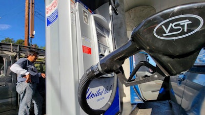 A motorist pumps gasoline at United Oil gas station in Los Angeles Friday, Aug. 12, 2022. The average U.S. price of regular-grade gasoline plummeted 45 cents over the past two weeks to $4.10 per gallon. Industry analyst Trilby Lundberg of the Lundberg Survey said Sunday, Aug. 14, 2022, that the continued decline comes as crude oil costs also remain low.