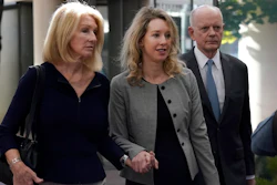 Former Theranos CEO Elizabeth Holmes, middle, and her mother, Noel Holmes, left, arrive at federal court in San Jose, Calif., Thursday, Sept. 1, 2022.