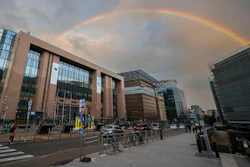 A rainbow forms between the European Council building, left, and the European Commission building right outside a meeting of EU energy ministers in Brussels, Friday, Sept. 9, 2022.
